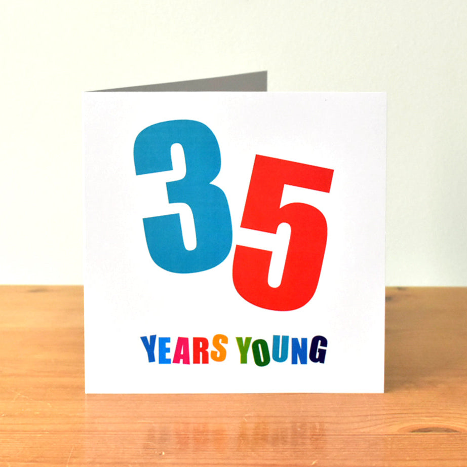 Square white birthday card with the large, bold number "35" prominently displayed. Each digit of "35" is at a different angle and in a different bold colour. Below the number, the words "Years Young" are written, with each letter in a different bold color.