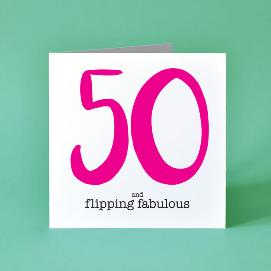 Greeting card with large bright pink '50' and 'and flipping fabulous' text in black underneath.