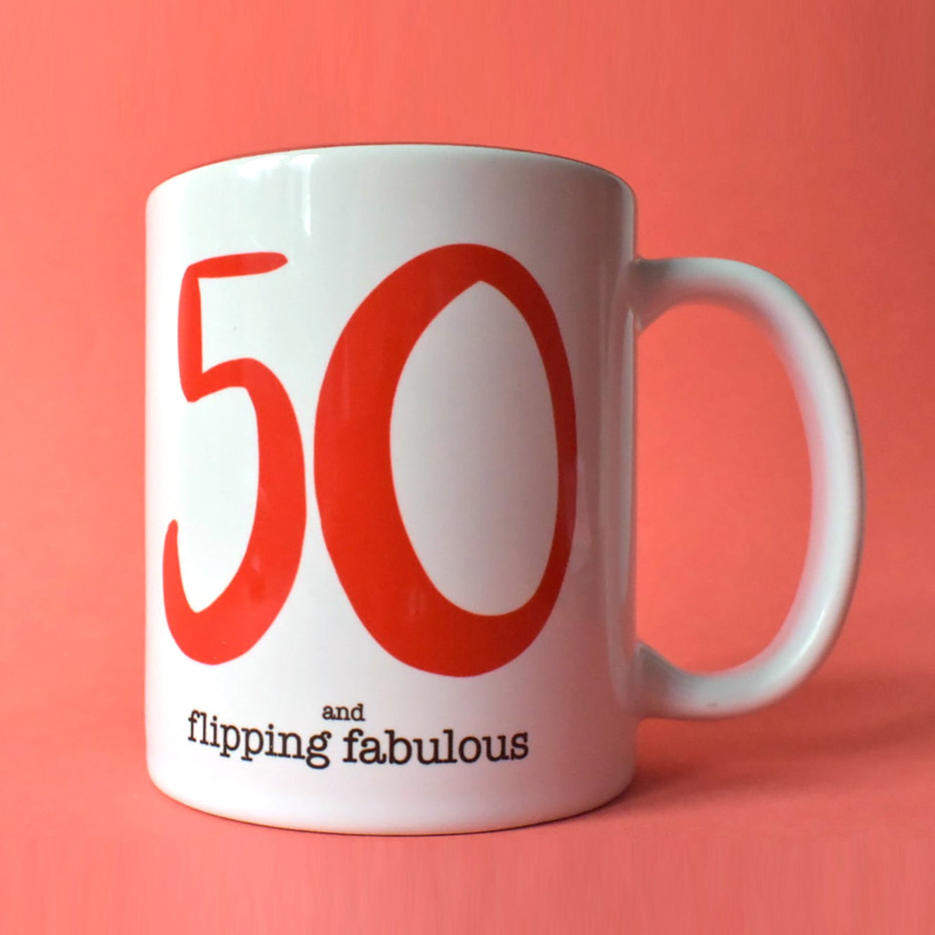Front view of a "50 & Flipping Fabulous" mug, showing its bold red "50" and text. A unique birthday mug for a fabulous 50th celebration.