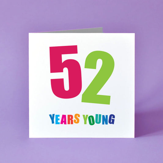 A bold and bright 'Fifty-Two Years Young' birthday card, designed with cheerful colours and dynamic typography.