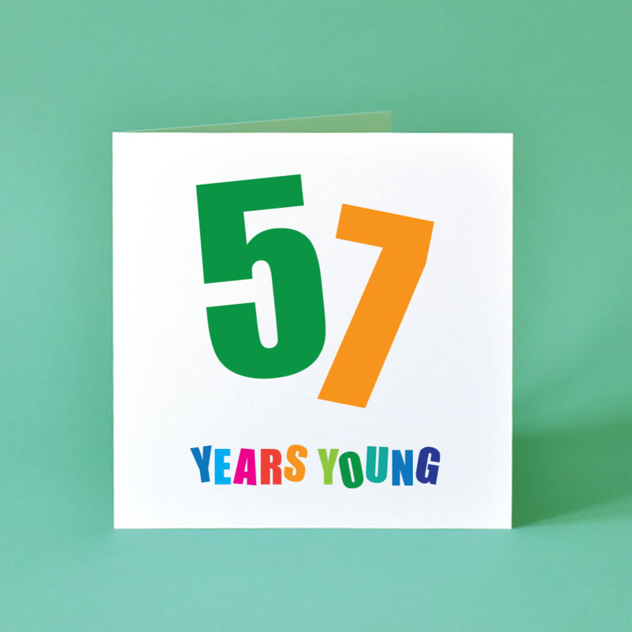 A bright and cheerful 'Fifty-Seven Years Young' birthday card, with a colourful, dynamic design and expressive typography.