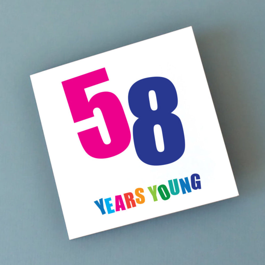 lose-up of a joyful 58th birthday card, featuring vibrant typography and a celebratory theme for a special occasion.