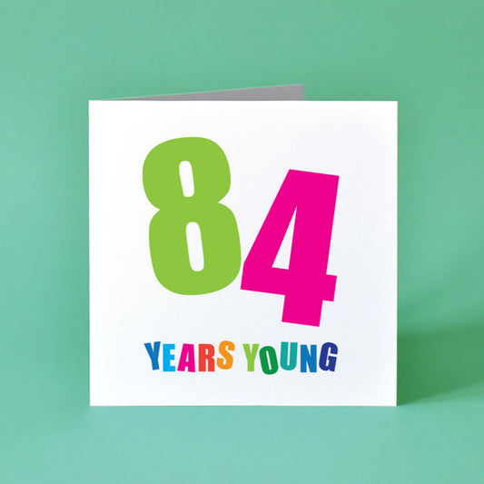 84 Years Yuung Birthday Card for Her with bold, colourful text.