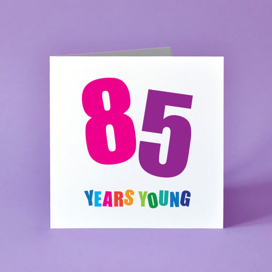Birthday card with '85 Years Young' text in bright colours for him or her.