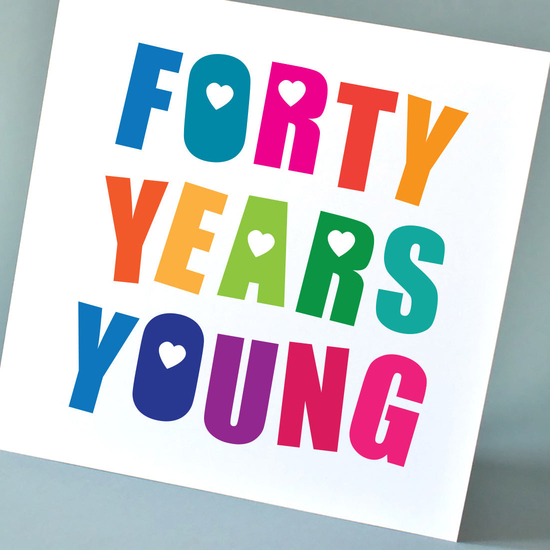 Close-up of a 'Forty Years Young' birthday card, with an optimistic and playful design bursting with bright colours and stylish typography