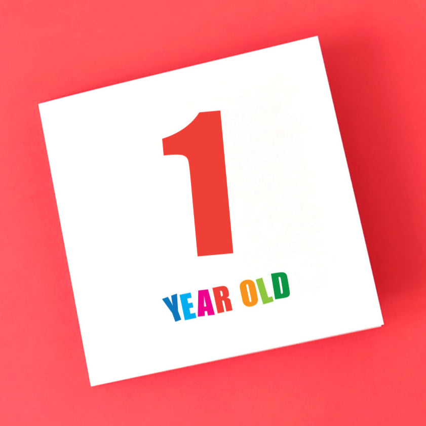 1st birthday age card for all genders of children. A large number 1 in red and Year Old is underneath in multi-colours.