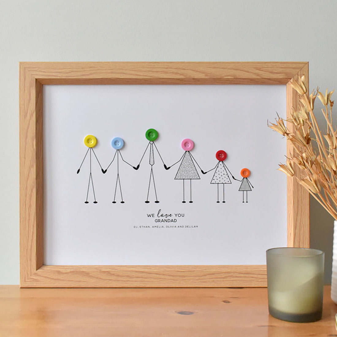 Fully personalised A3 print showing grandad and his grandchildren as stick drawn characters with coloured button heads. All characters are holding hands. Underneath the line up are the words 'We Love You Grandad" followed by the name of all he grandchildren.