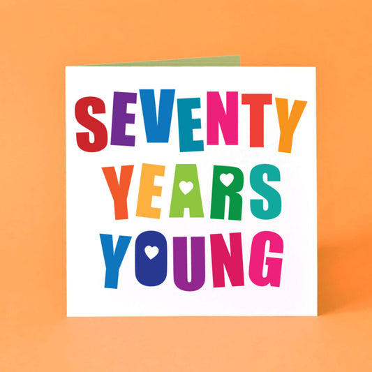 Square white birthday card featuring large, bold, angled, multicoloured "Seventy Years Young".  Design includes playful love hearts and a fun typeface. Ideal for a 70th birthday celebration or milestone.