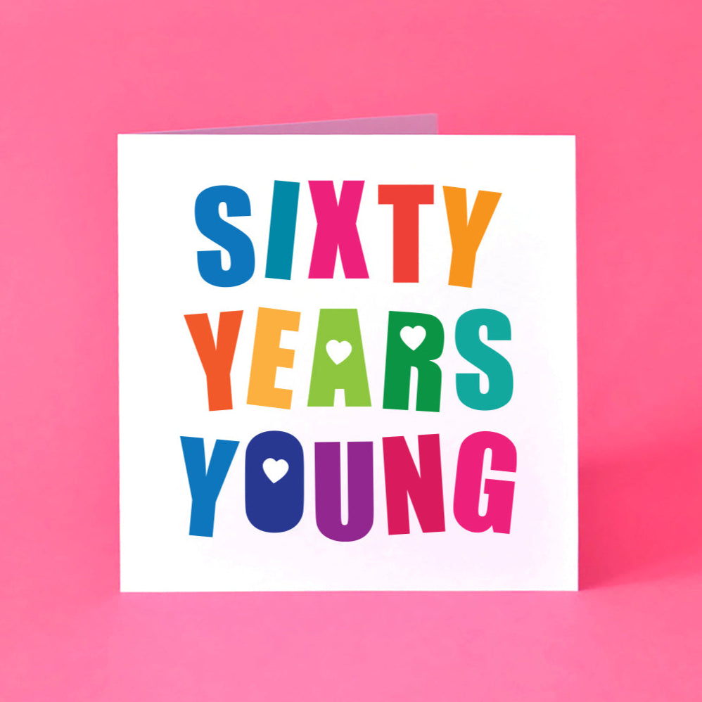Square white 60th birthday card featuring large, bold, angled, multicoloured letter reading "Sixty Years Young".  The design includes playful love hearts and a fun typeface.
