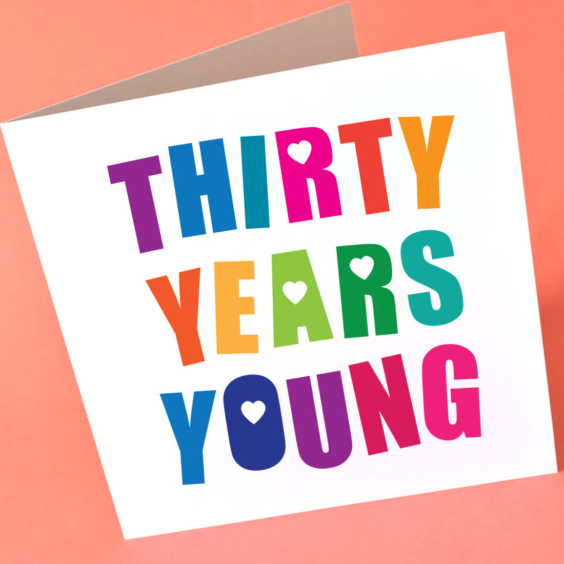 Square white card with the colourful words Thirty Years Young across the whole birthday card.