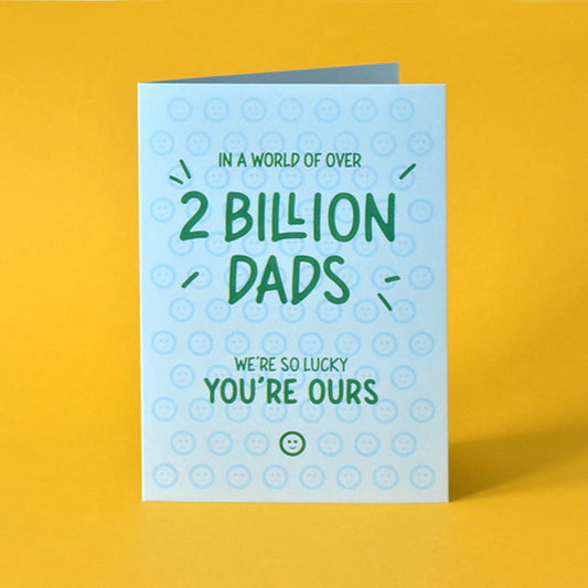 Heartfelt Father’s Day card reading “In a world of over 2 billion dads, we are so lucky you are ours” in a fun green font.