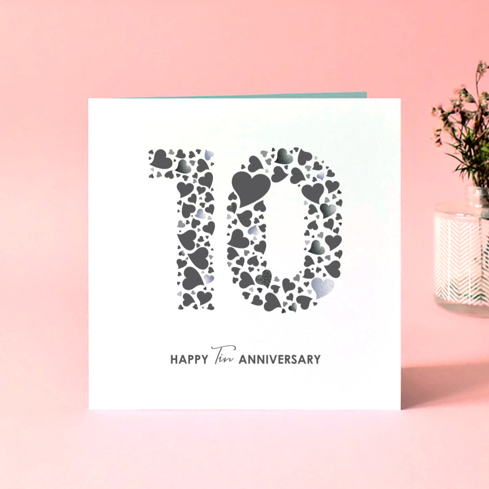 Tin 10th wedding anniversary card with a heart design making the number ten and 'Happy Tin Anniversary' underneath in a mix of serif and sans serif fonts.