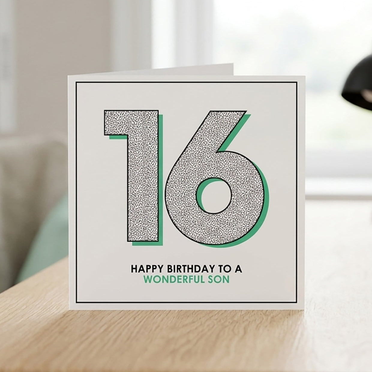 Square white 16th birthday card with a bold number sixteen and green drop shadow.