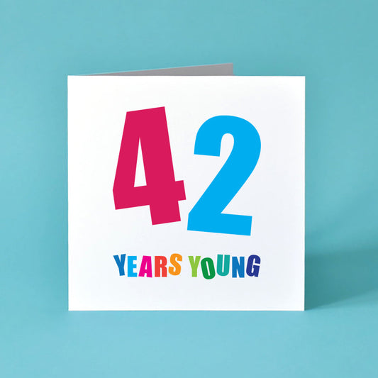 The birthday card proudly displays a prominent '42', with each number in a different vibrant hue and angled playfully. Below, "Years Young" adds a cheerful touch, each letter popping with its own distinct colour.
