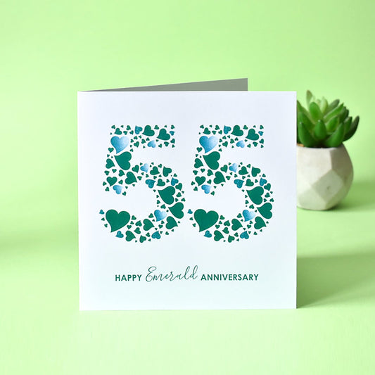 Emerald Wedding Anniversary card with a white background featuring a dense pattern of emerald green love hearts arranged to form the number '55', with the text 'Happy Emerald Anniversary' printed on it.