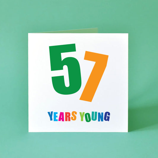A bright and cheerful 'Fifty-Seven Years Young' birthday card, with a colourful, dynamic design and expressive typography.