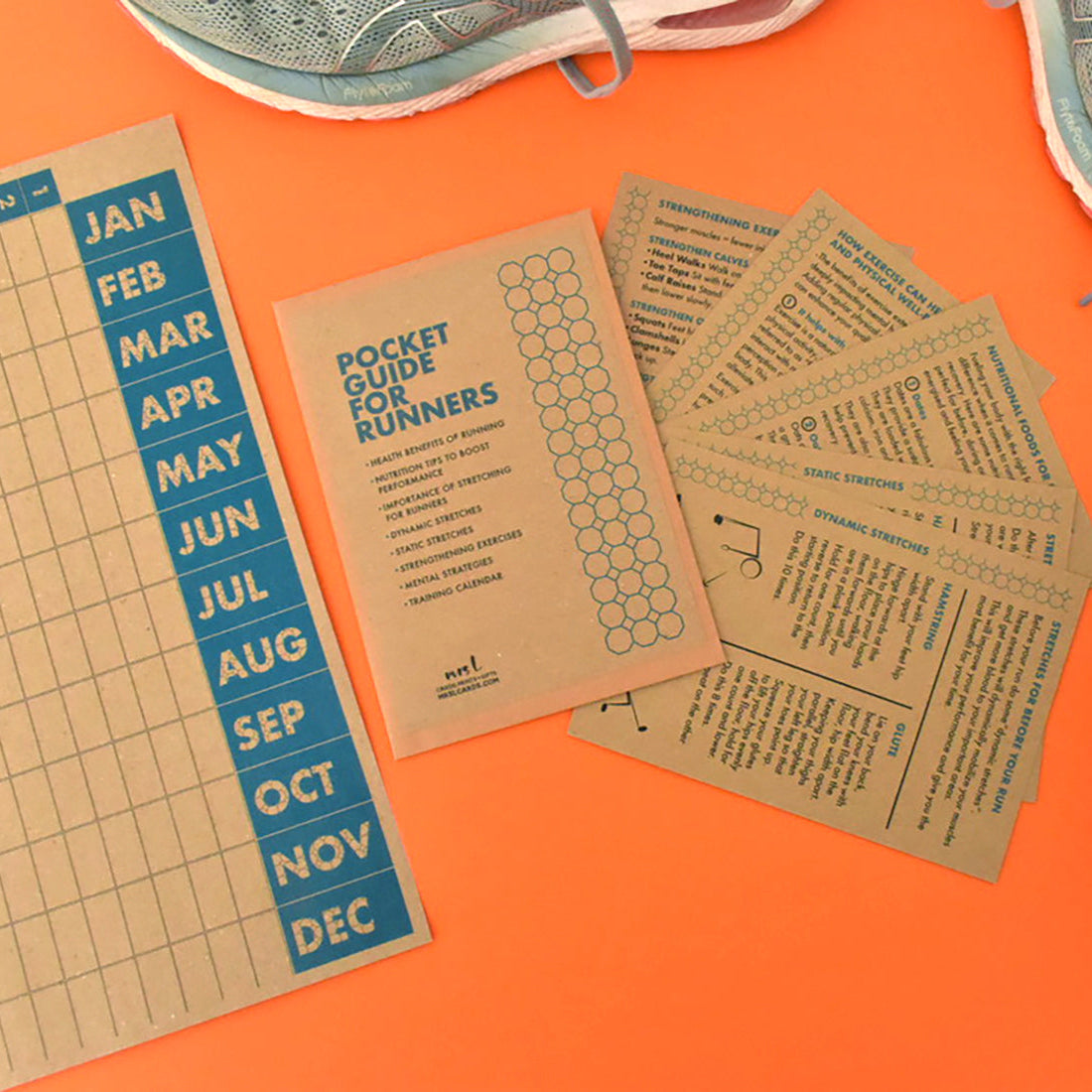 Flat lay of Pocket Guide for Runners with kraft A6 wallet and motivational cards displayed.