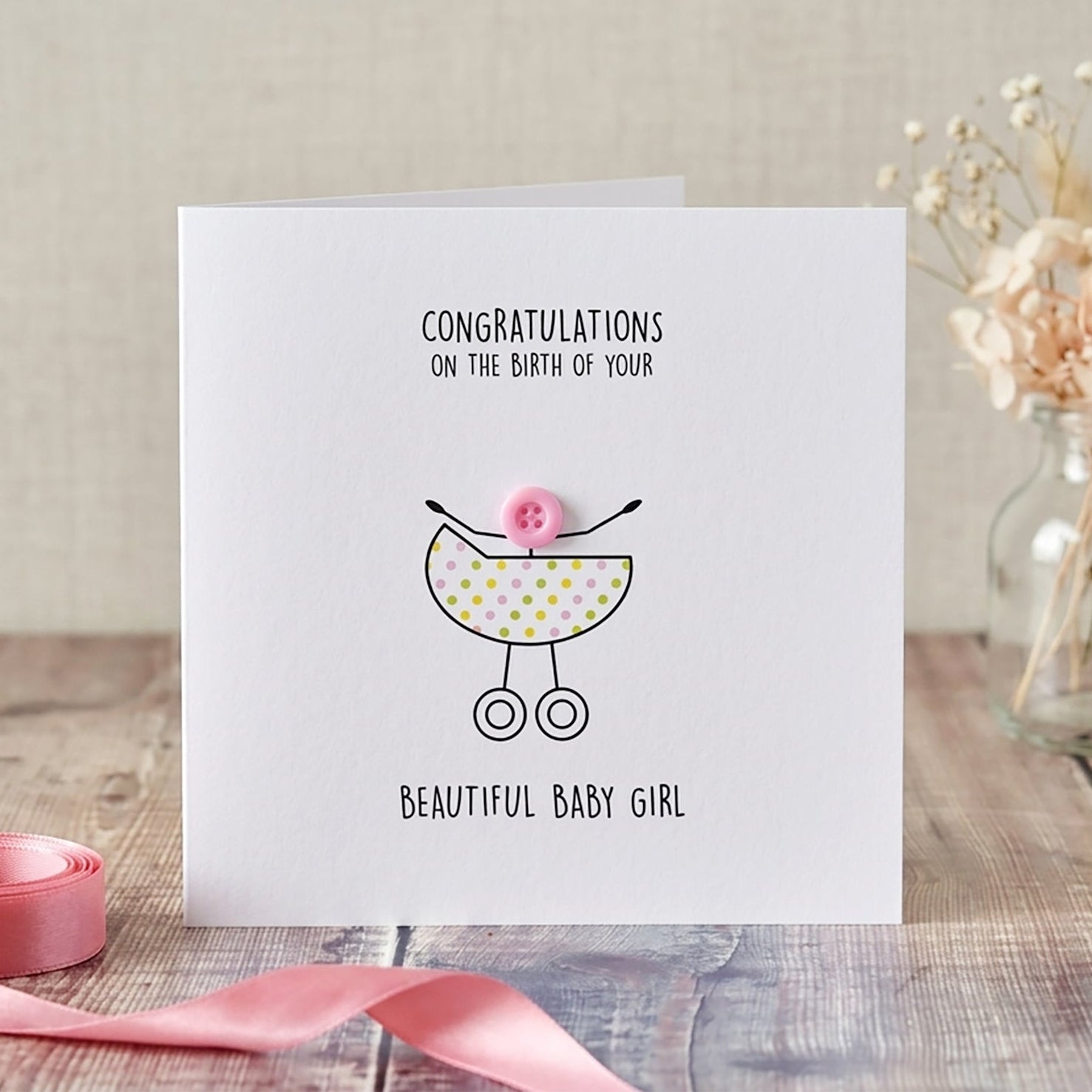 Greeting card for a new baby girl with a pram illustration.