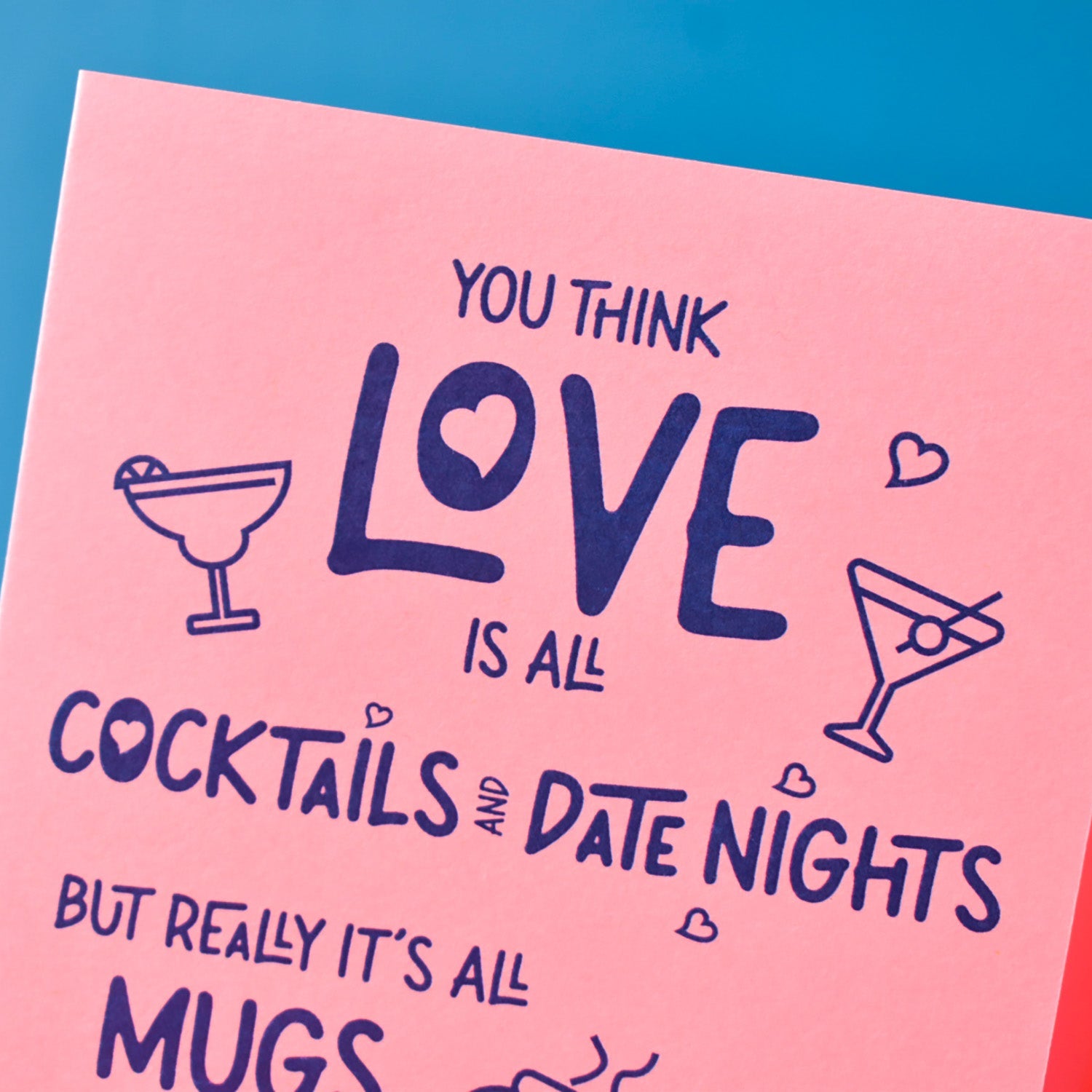 Pink card with blue text and cocktail illustrations on a blue background
