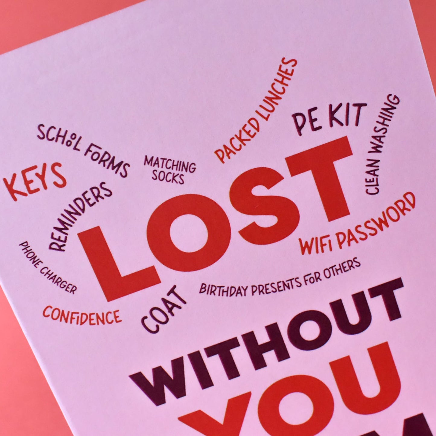 A colourful greeting card with text 'LOST WITHOUT YOU' in bold letters and other words such as 'keys', 'confidence', 'coat', 'PE Kit', 'lunch money', 'birthday presents for others' in a playful font.