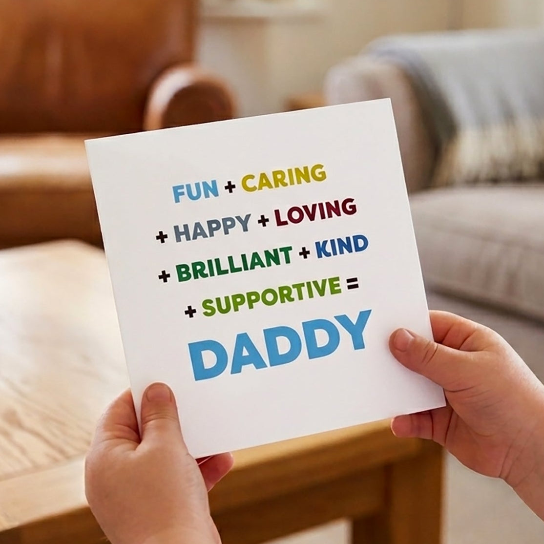 Person holding a card with positive attributes of a father in a living room.