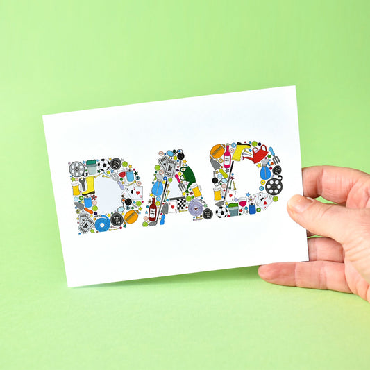 White A6 card with the word Dad written in capital letters and made from illustrations of such things as: footballs, gardening hose, trowel and watering can, pint of beer, bottle of wine, plants, film reel, playing cards, rugby ball, gold clubs and balls, cinema tickets, tennis balls and snooker balls.