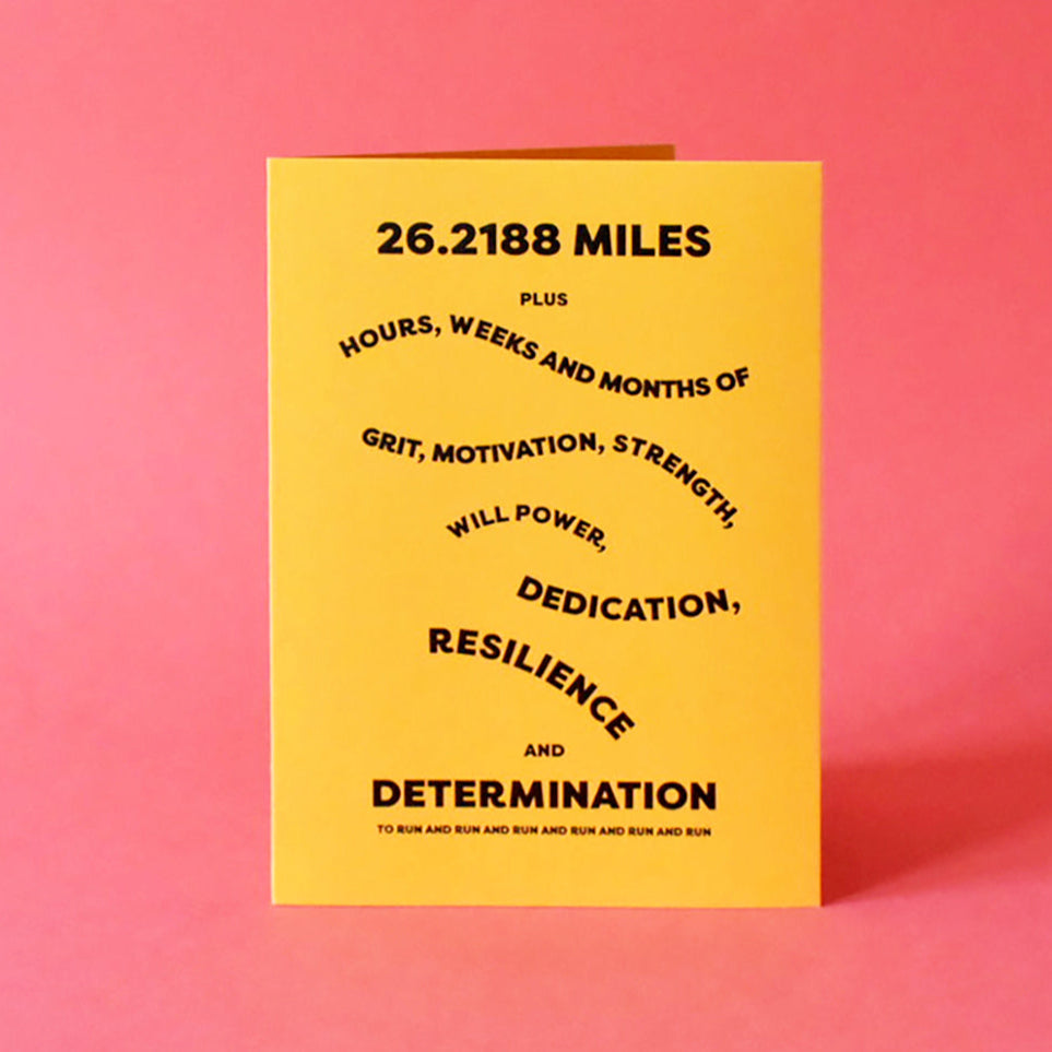 Card that reads "26.218 miles plus hours, weeks and months of grit, motivation, strength, will power, dedication, resilience and determination".
