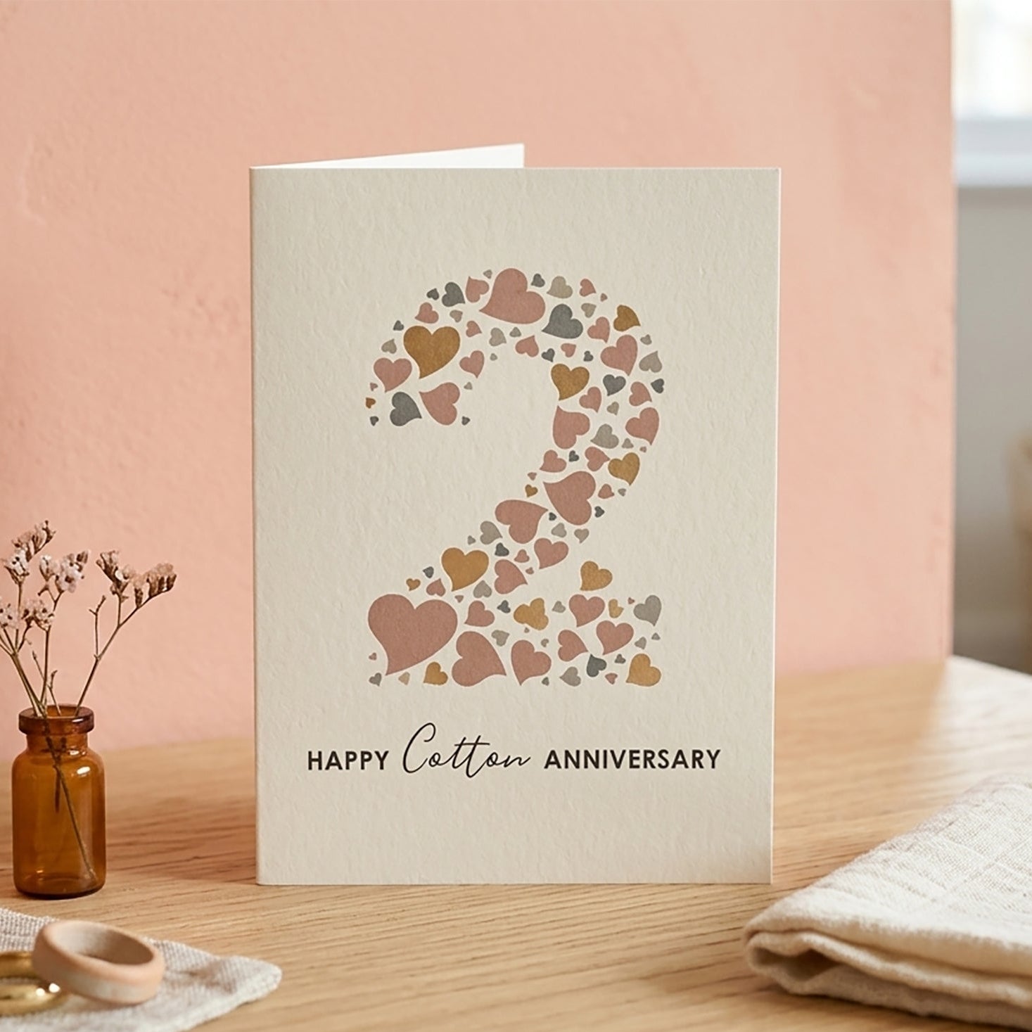 Cream card with heart design to form a large number 2 and underneath are the words 'Happy Cotton Anniversary'.
