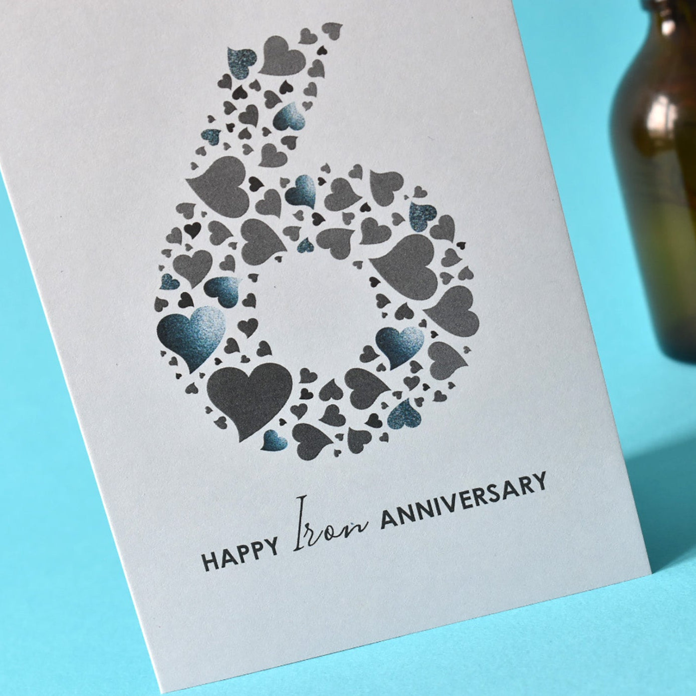 Huge number 6 in shades of grey love hearts with the words Happy Iron Anniversary underneath.