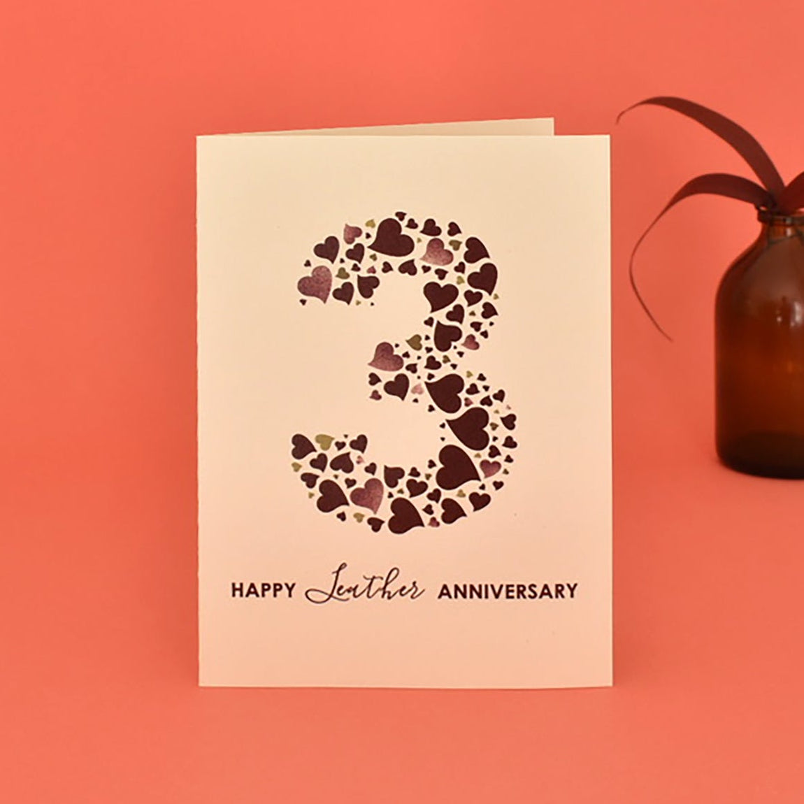 A6 cream card with large number 3 made from a collection of love hearts in "leather" shades. Underneath the message reads "Happy Leather Anniversary".