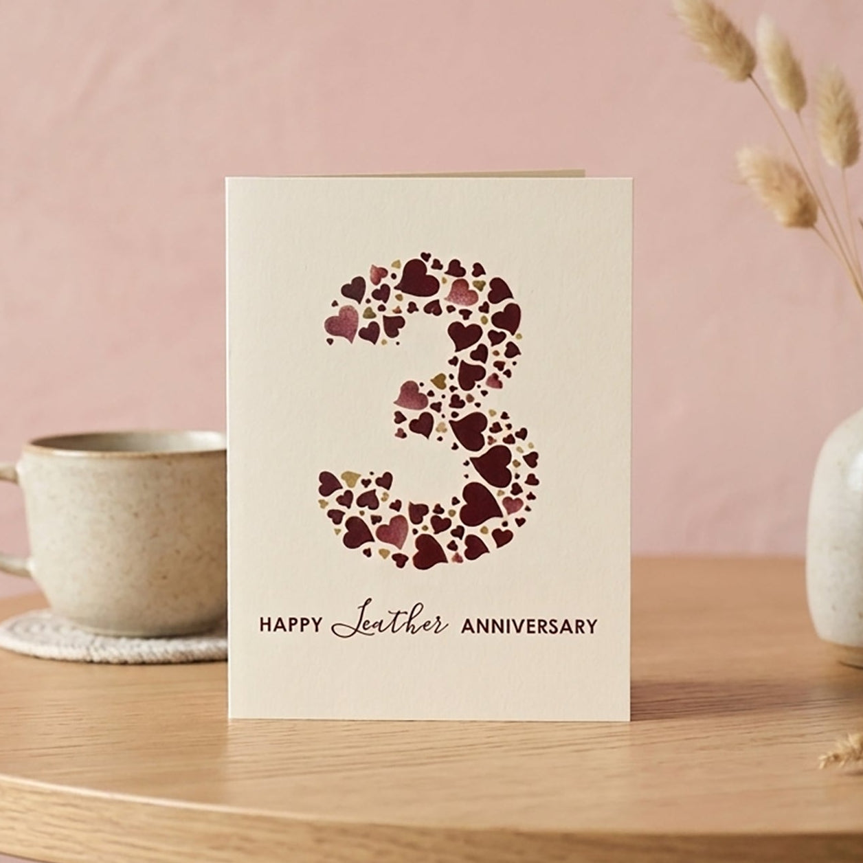 A6 cream card with heart design making up a large number 3 and 'HappyLeathernAnniversary' text underneath.