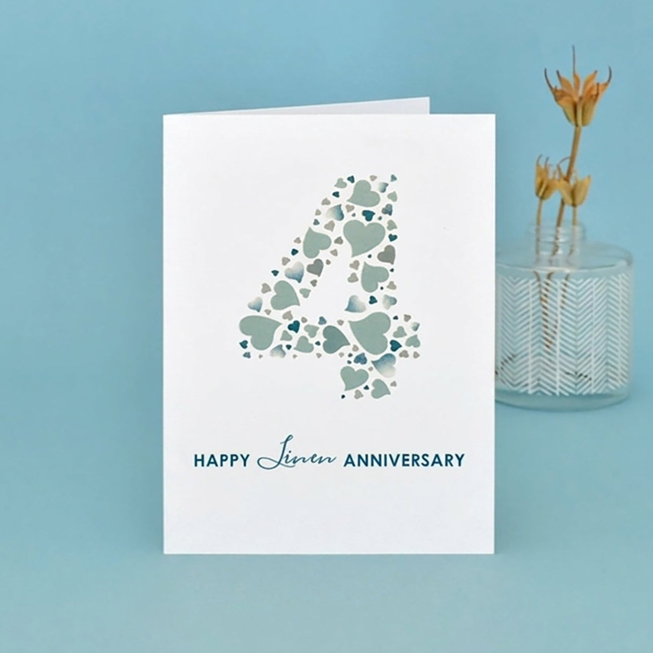 Card with heart design and 'Happy 4th Anniversary' text on a blue background