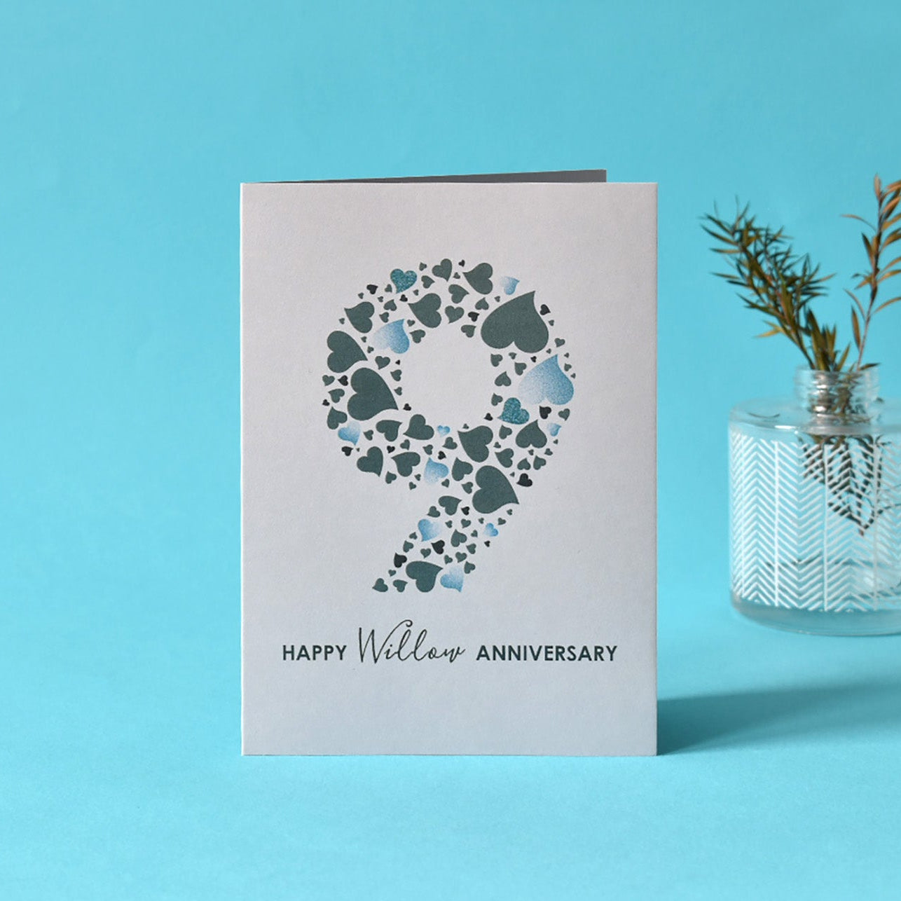 9th anniversary card with a large number 9 made from an array of love hearts, underneath is the message 'Happy Willow Anniversary'.nPrinted on pale grey card.