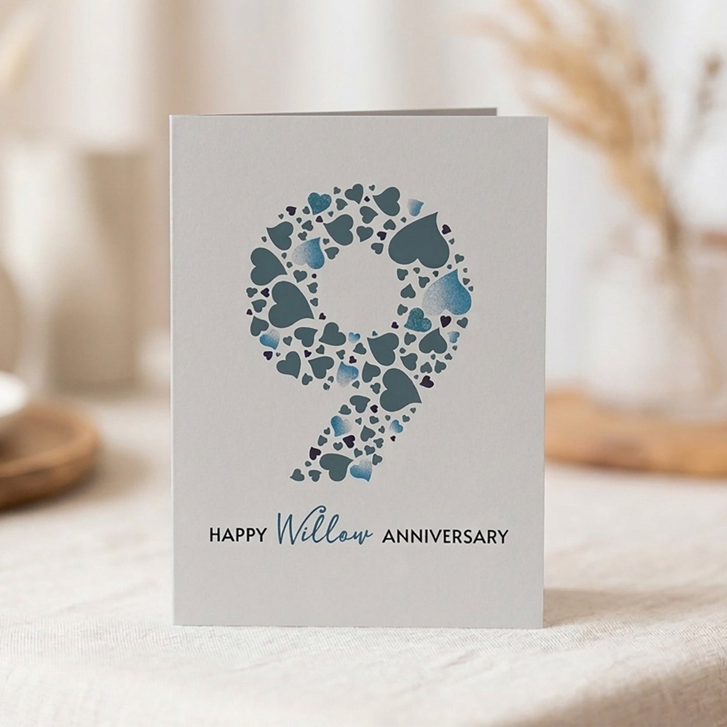 Card with heart design making up the large number 9 and 'Happy Willow Anniversary' text on a neutral background.