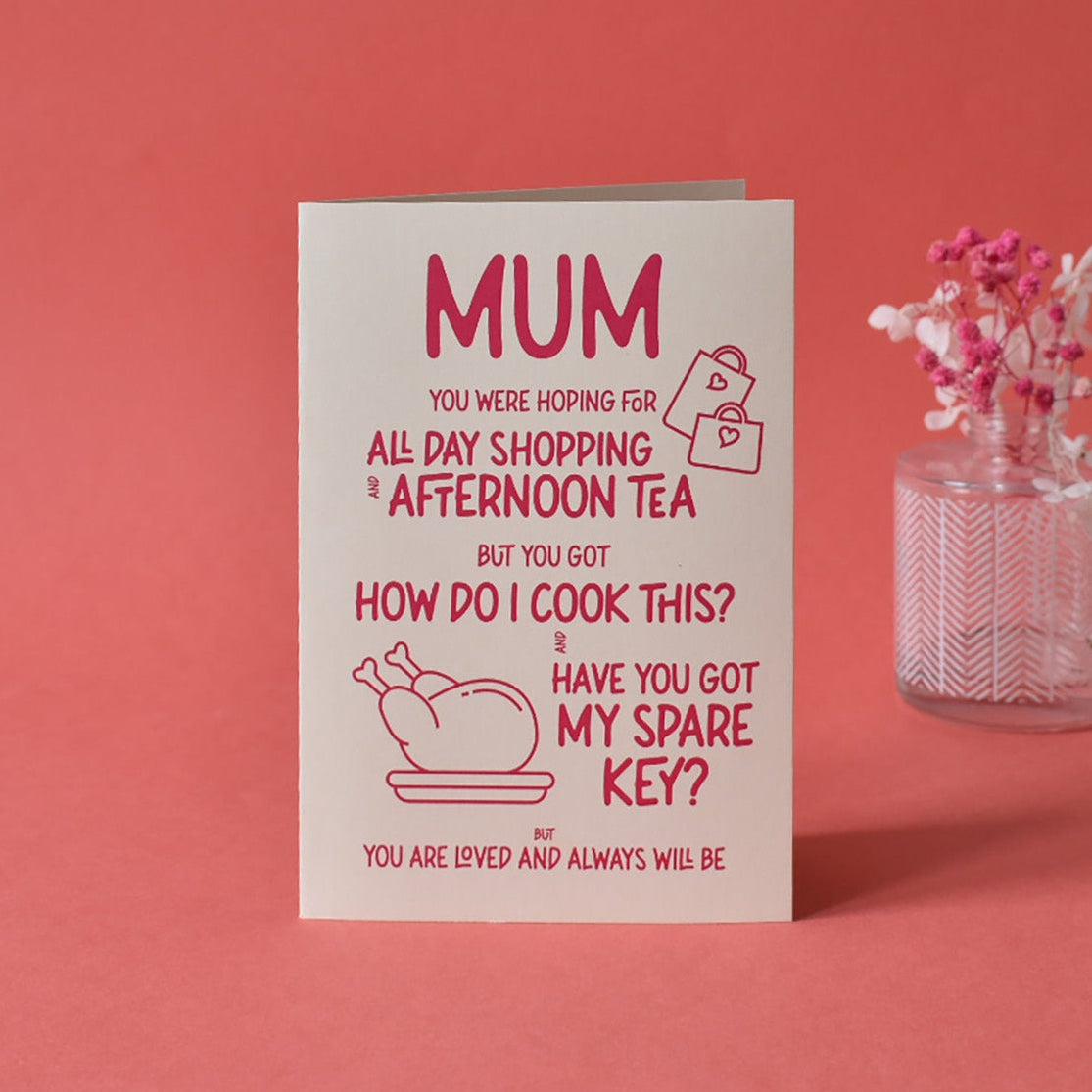 Close-up of funny "Mum you were hoping for all day shopping" greeting card text, highlighting the red lettering and cream card.