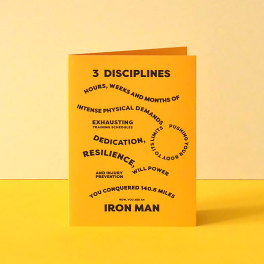 Bright yellow A6 card that lists the dedication and endurance needed to complete a full Ironman of swimming, cycling and running.
