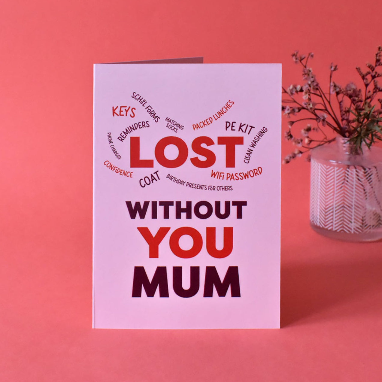 Pink greeting card for Mum featuring a playful red and burgundy typography design. The card celebrates the 'household CEO' who manages everything from school forms and PE kits to remembering phone chargers and the Wi-Fi password.