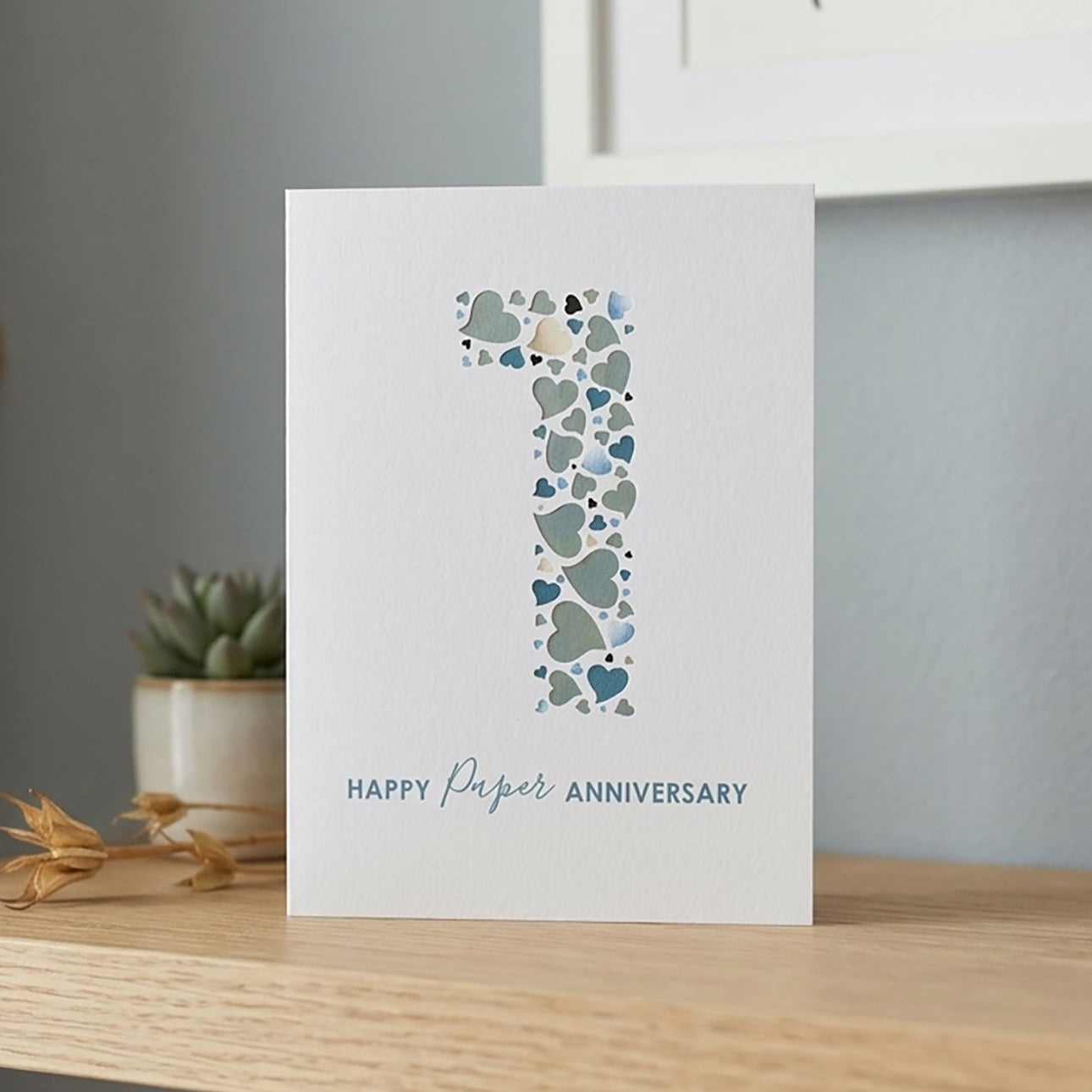 Card with a huge number '1' and 'Happy First Anniversary' text on a white background.