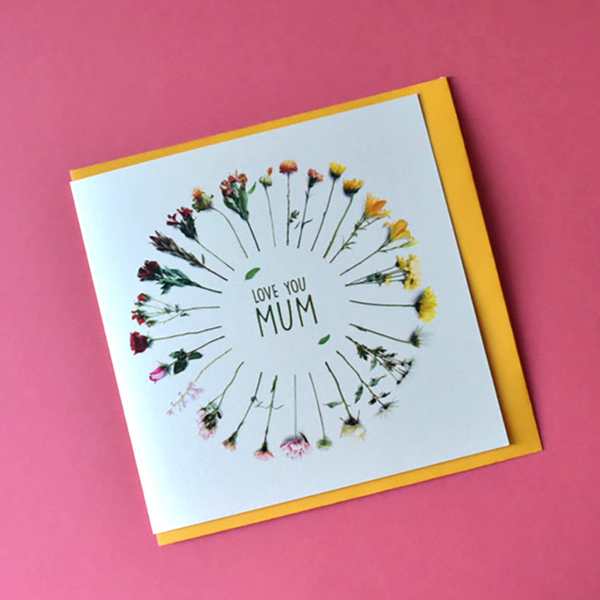 Cream card with a circle of different colour flowers and in the centre the words "Love You Mum".