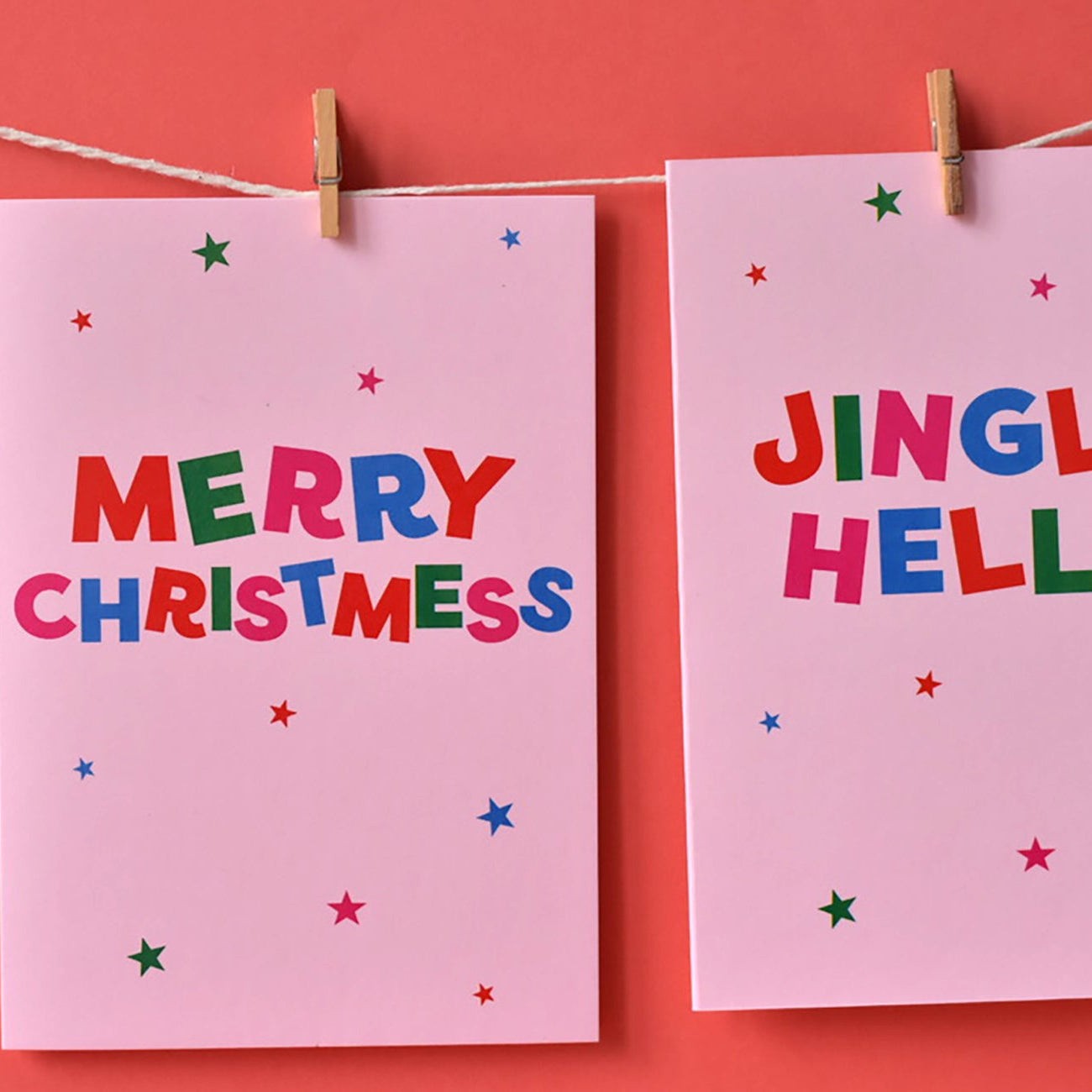 Two pink funny Christmas cards with colourful text on a pink background.