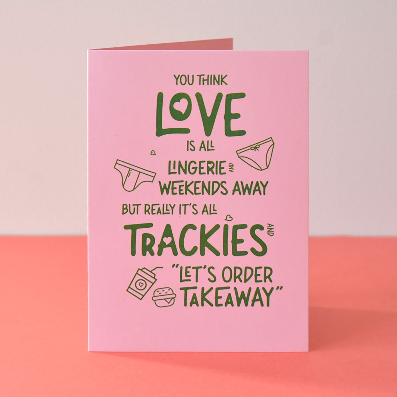 Pink card with humorous text on a pink background - real love Valentines card for partner.