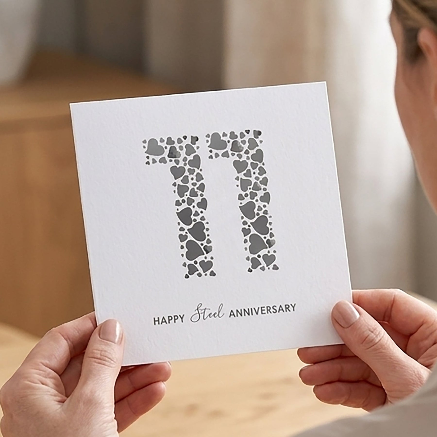 Modern 11th Steel Anniversary Card with large number 11 filled with grey love hearts.