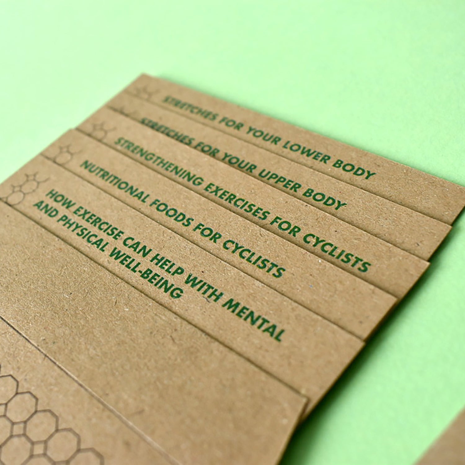 Close-up of cyclist training cards showing strengthening exercises and mental strategies.