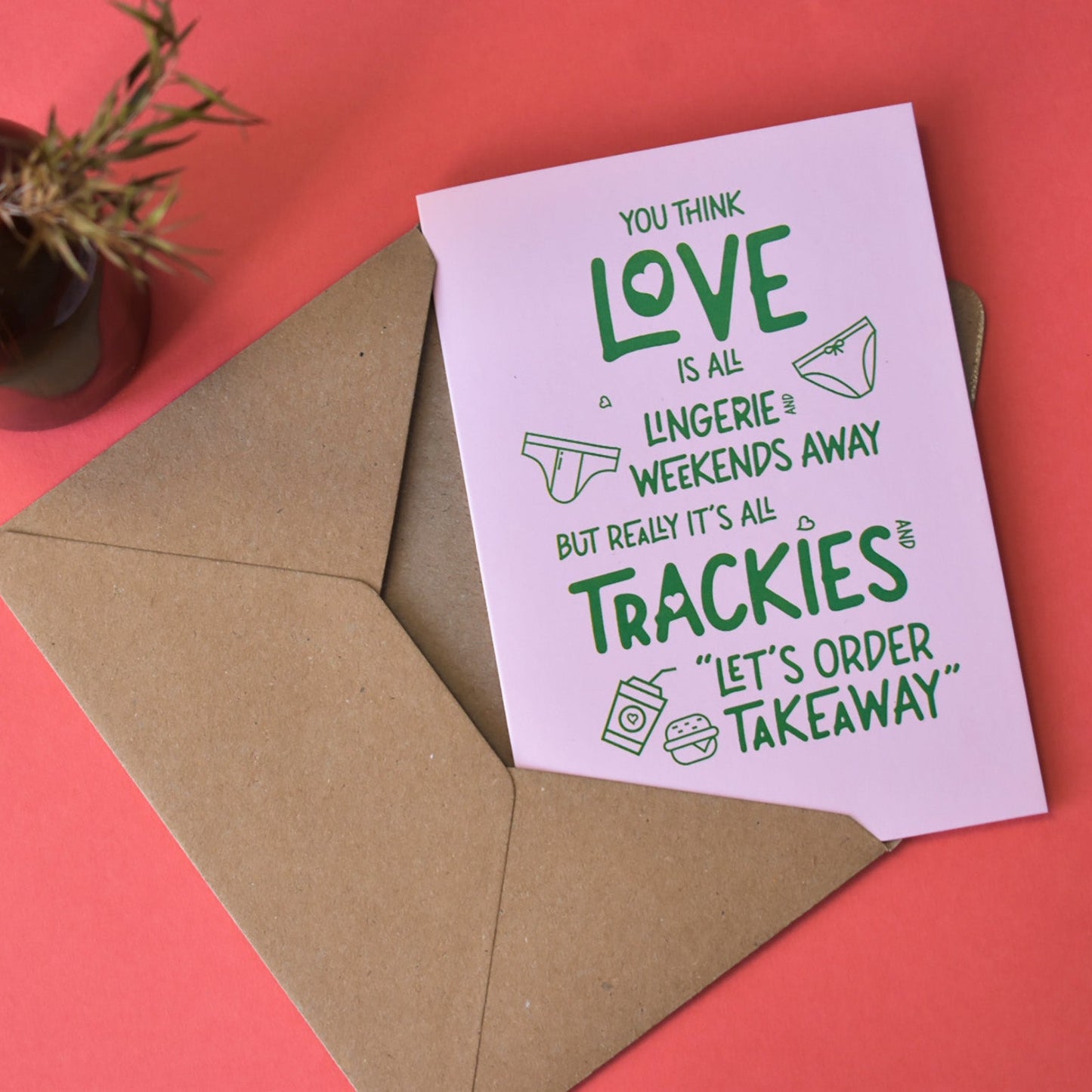 Card with humorous text on a pink background with an envelope