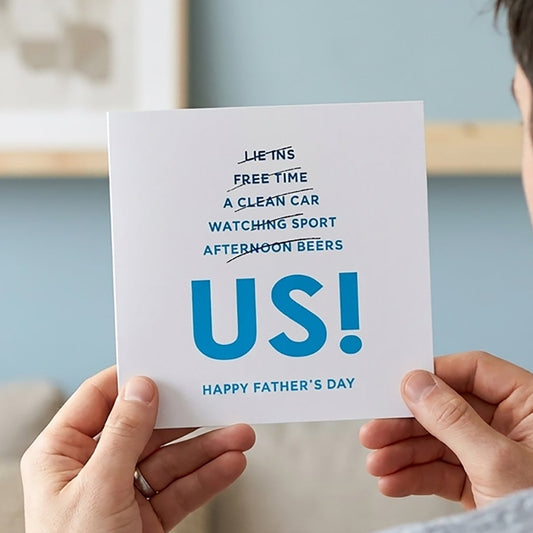 Person holding a Father's Day card with text that reads Ombré blue text lists out all the things dad might hope for: "Lie-ins, Free Time, A Clean Car, Watching Sport, Afternoon Beers" — each one cheekily crossed out.

And in bold, unapologetic letters? “Us.”