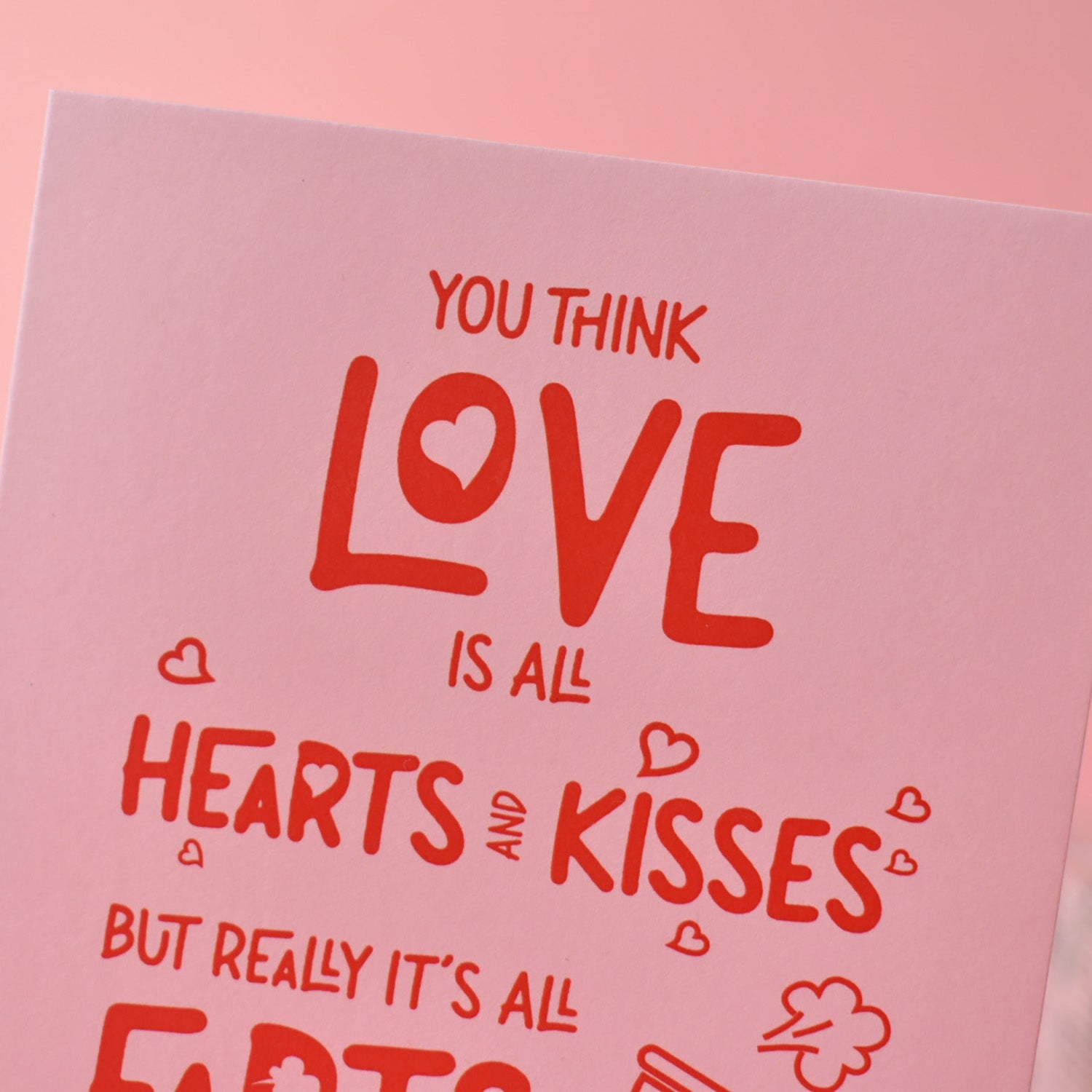 Pink card with red text on a pink background